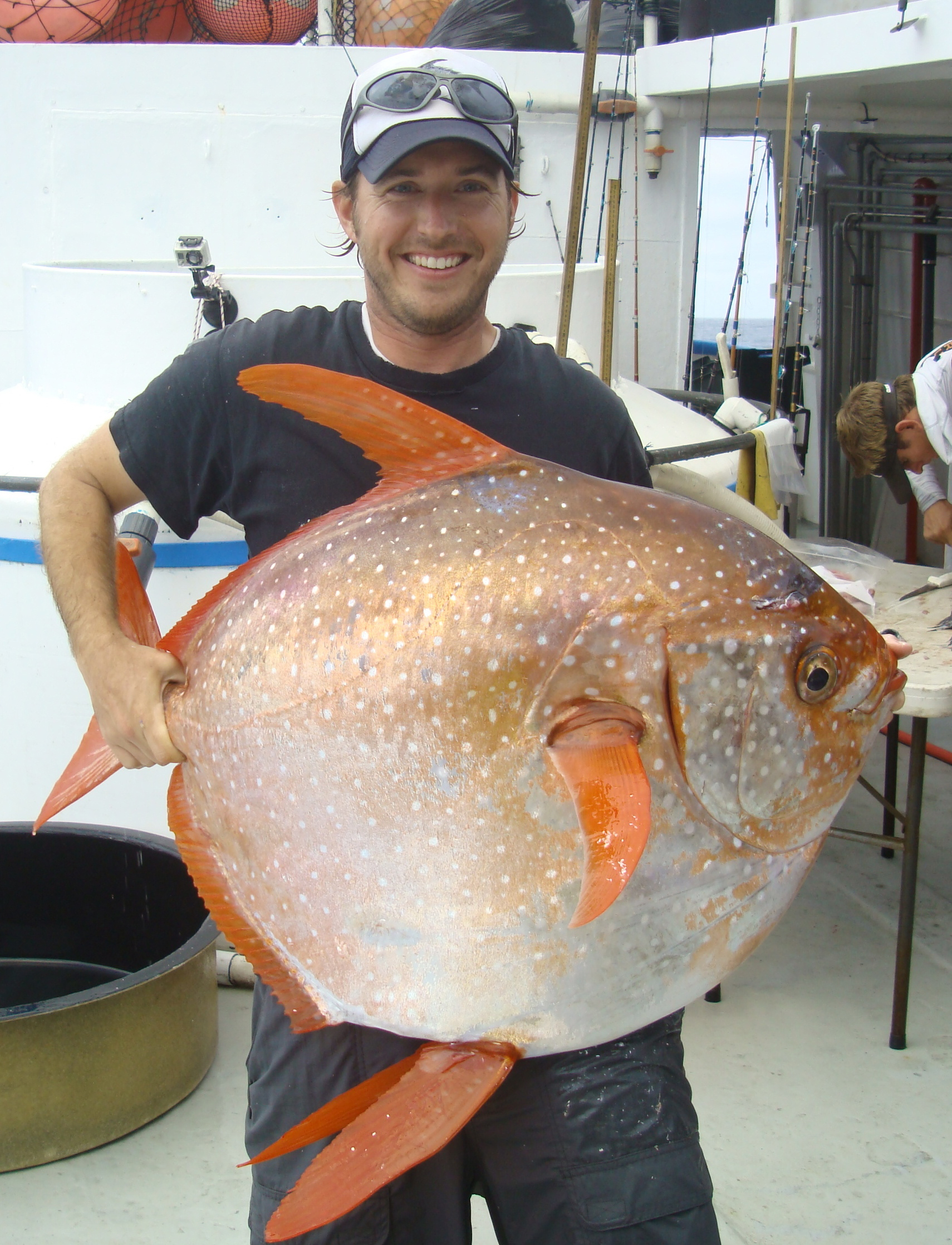 US NOAA biologist Nicholas Wegner holding an opah fish (credit: NOAA Fisheries/Southwest Fisheries Science Center)