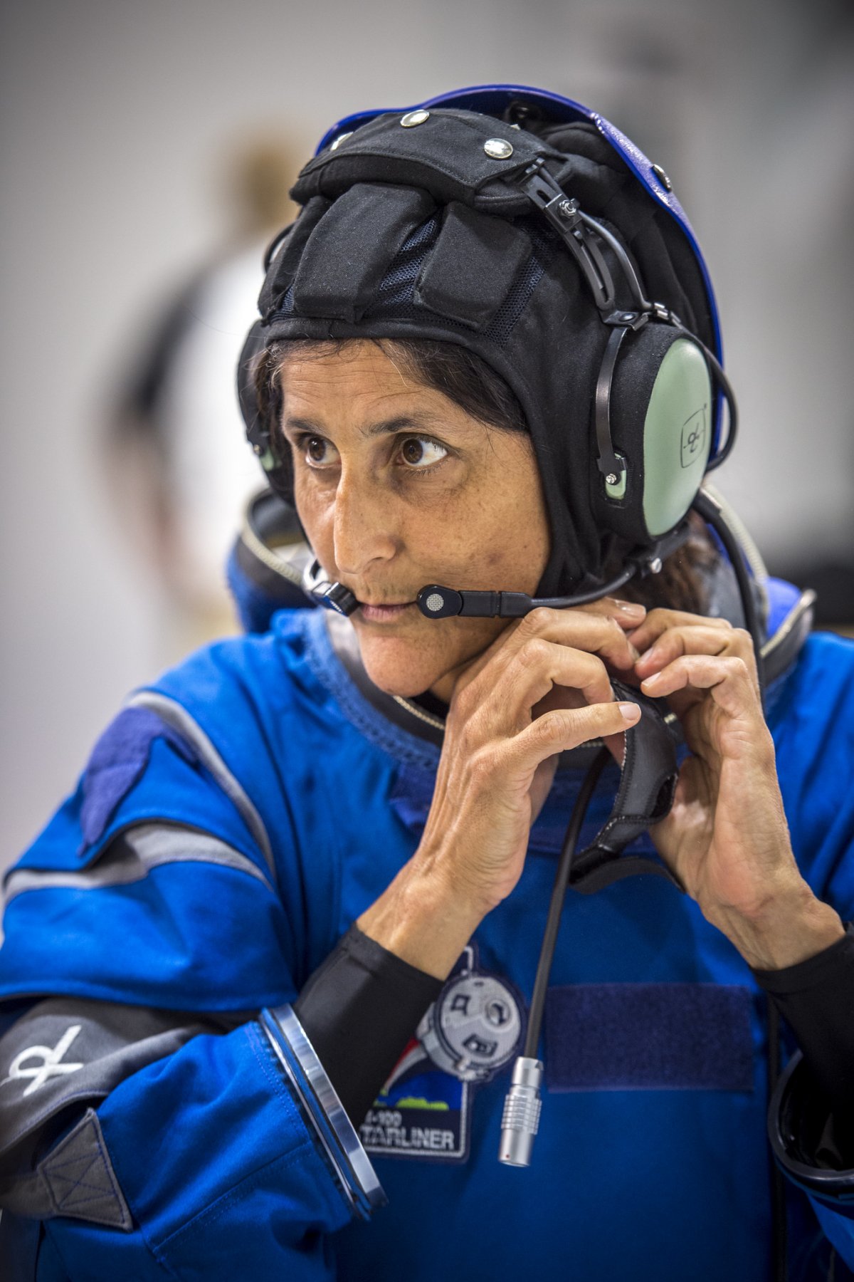 nasa-astronaut-suni-williams-wears-the-usual-snoopy-cap-communications-systems-which-go-under-the-starliners-helmet