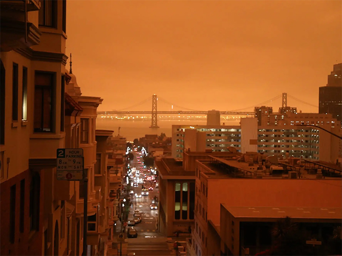 looking at the bay bridge with red skies