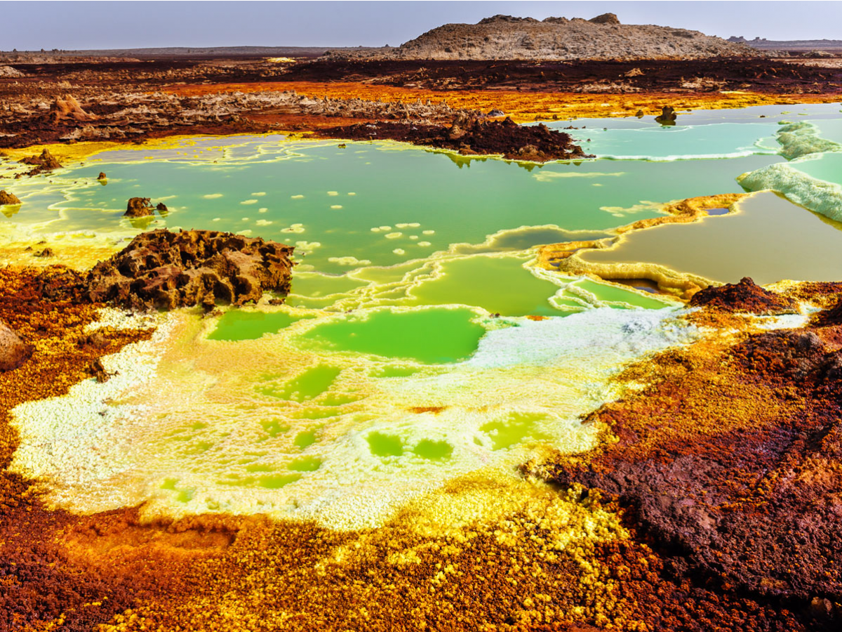 the-danakil-depression-in-the-northeastern-corner-of-ethiopia-is-one-of-the-hottest-places-on-the-planet-with-temperatures-reaching-as-high-as-145-degrees-fahrenheit-with-two-active-volcanoes-a-bubbling-lava-lake-geysers-acid-ponds-and-seve