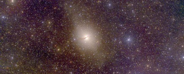 This huge galaxy has tiny galaxies orbiting it, like planets around a star