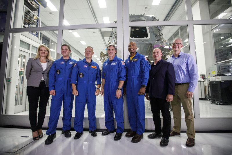 people infront of dragon spacecraft august 2018