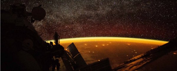 An astronaut on the ISS has caught an eerie orange glow above Earth