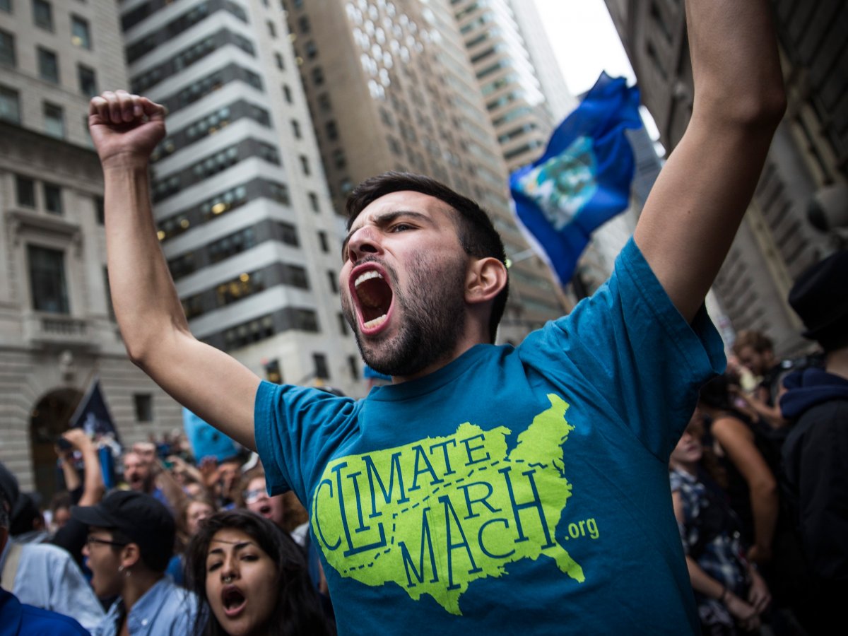 Climate protest sit-in around the Wall Street Bull statue in New York City. (Andrew Burton/Getty Images)