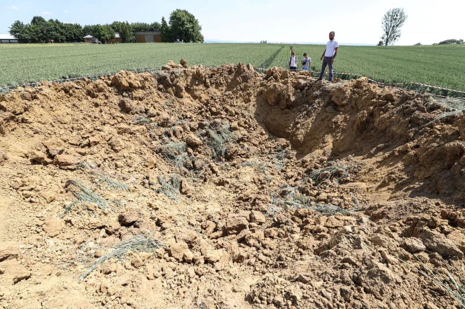 crater field ww2 bomb body pic