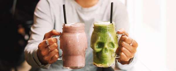 A person holding two smoothies