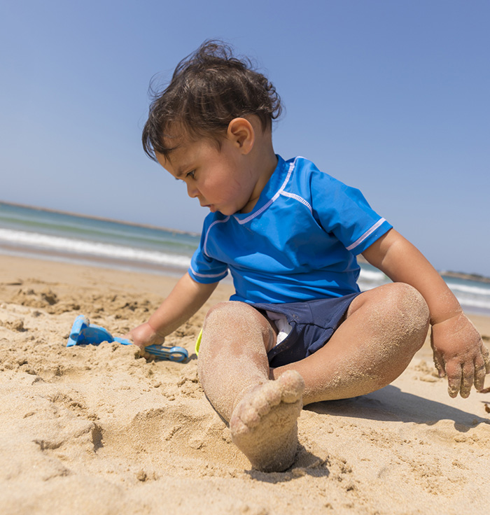 toddler playing on the beach