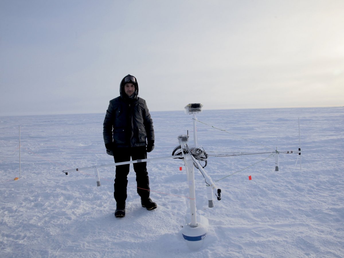 Ice911 volunteer, Vangelis Christoduoluo, stands next to a remote monitor that collects data on the beads' effectiveness. (Susan Kramer/Ice 911)