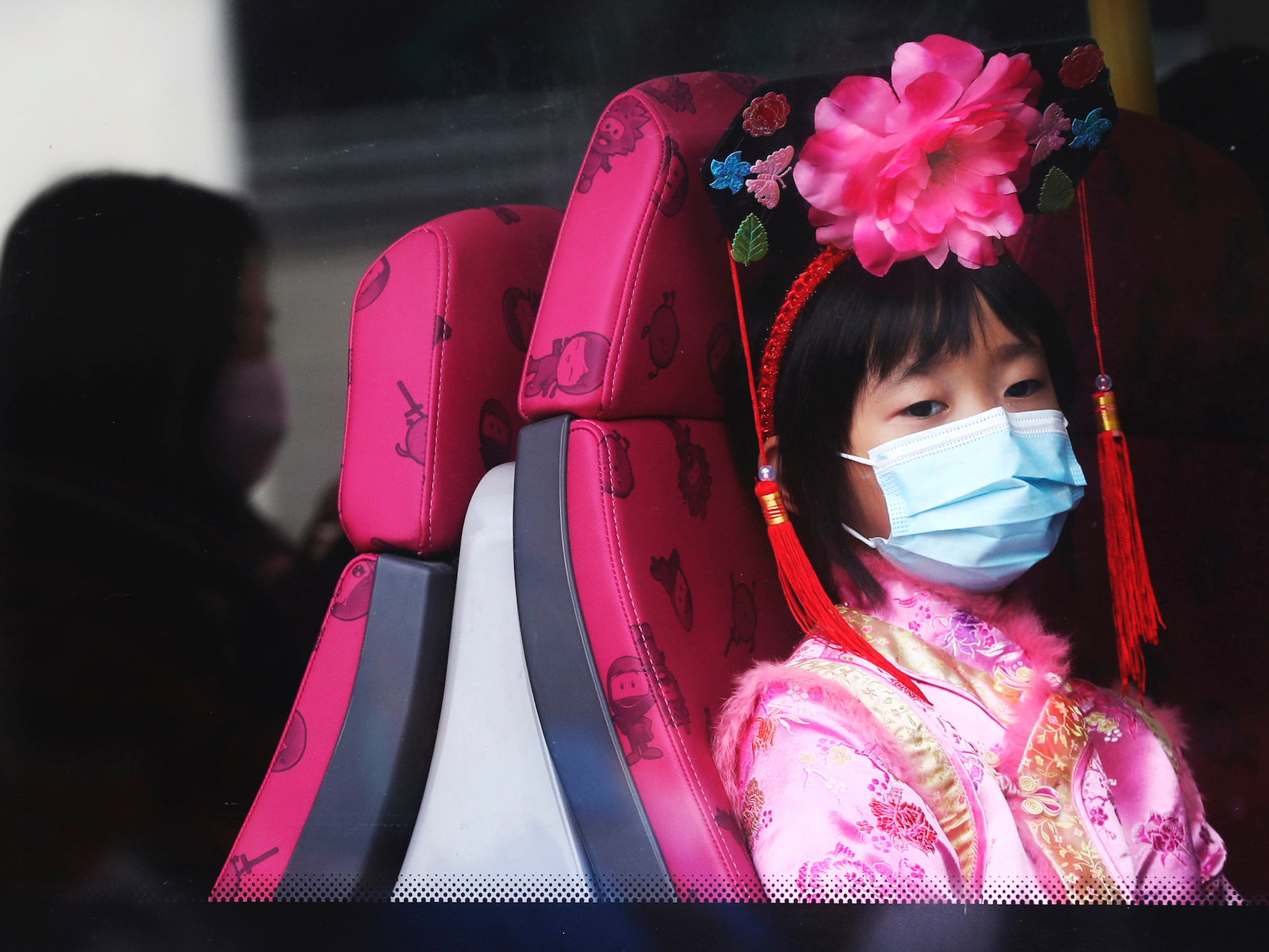 A girl on a bus in Hong Kong, January 25. (Achmad Ibrahim/AP)