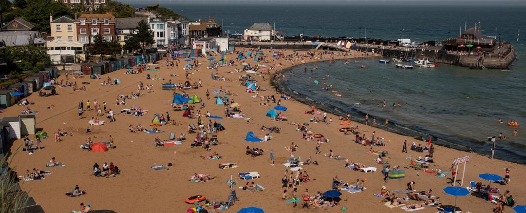 People relax on the beach at Viking Bay on June 26, in England. 