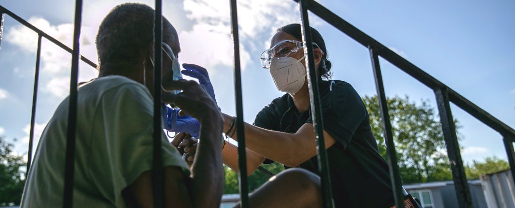 A medic provides oxygen to a patient in Houston, Texas on August 14. 