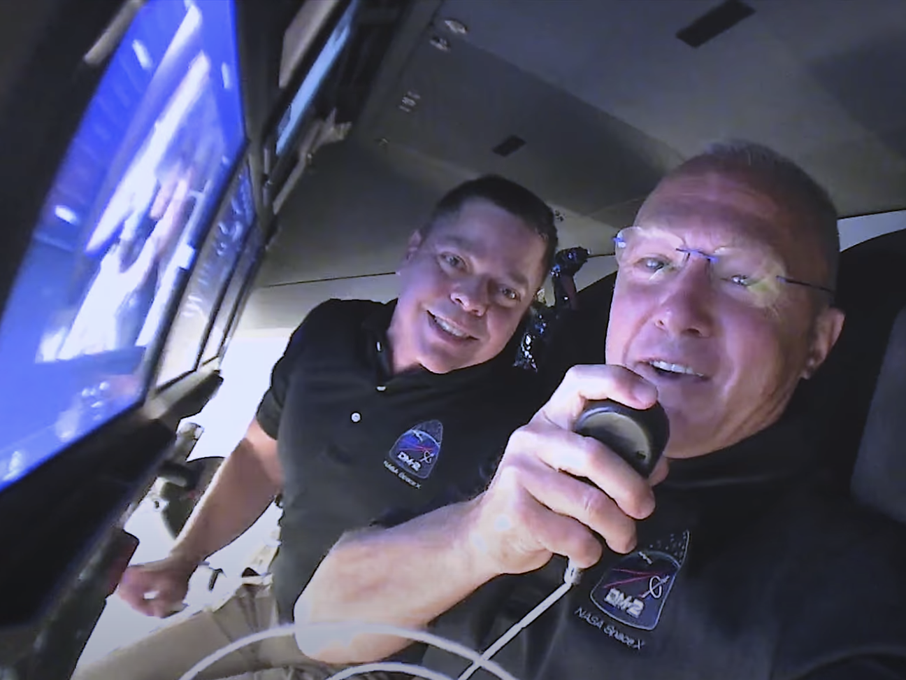  Bob Behnken (left) and Doug Hurley wish their families goodnight from inside the Crew Dragon capsule, May 30, 2020. (SpaceX)