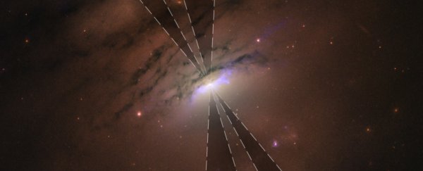 Hubble captures a black hole's 'shadow beams', yawning across space