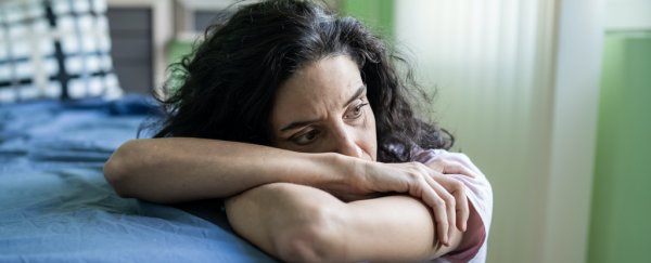 Middle-aged women with dark hair looking sad