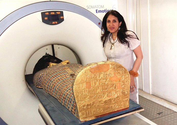 Sahar Saleem next to a mummy getting scanned