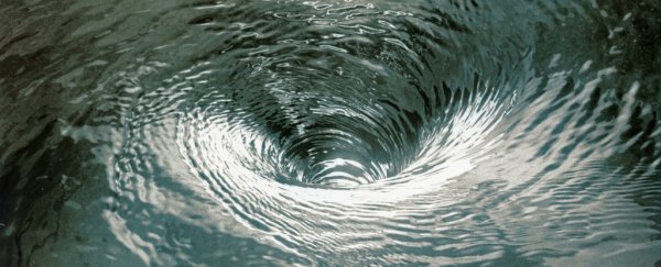 Swirling vortex of bathtub water reveals an elusive mechanism of black hole physics