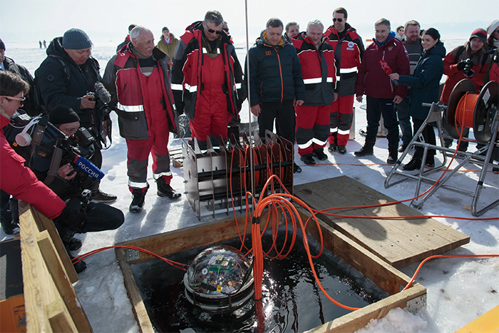 Scientists launching Baikal Gigaton Telescope into a lake