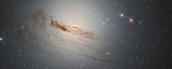 Haunting new Hubble photo reveals the wisps of a dying galaxy