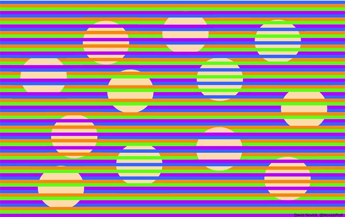 12 tan spheres of equal size with thin multi-coloured lines, some crossing over, making spheres seem different colours