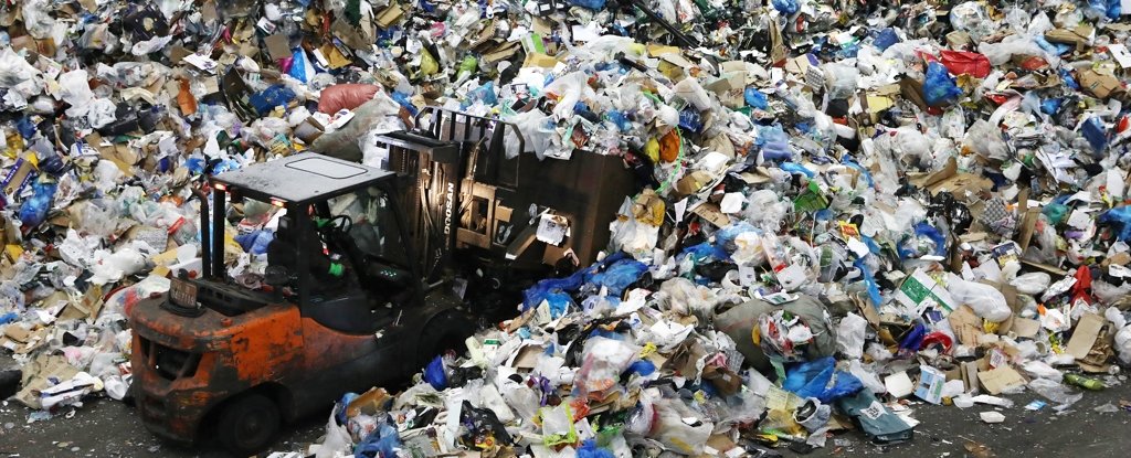 A worker moves household waste in Seoul, February 2021. 