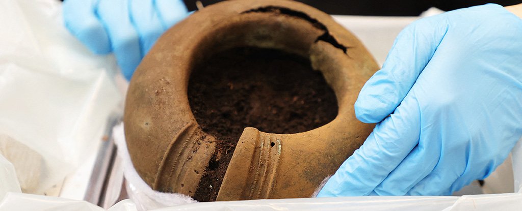 Curator Madelene Skogbert shows off a bone ring. 