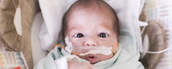 A baby with medical equipment attached