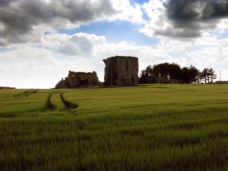 Stone ruins in the distance on a green hill