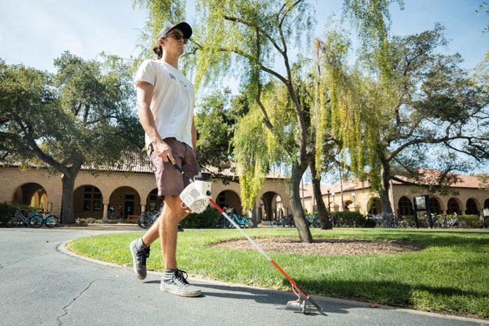Person uses a self-navigate smart cane around Stanford's campus.