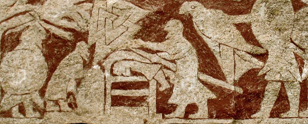 Man lying on his belly with another man using a weapon on his back.