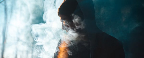 A person silouhetted in smoke