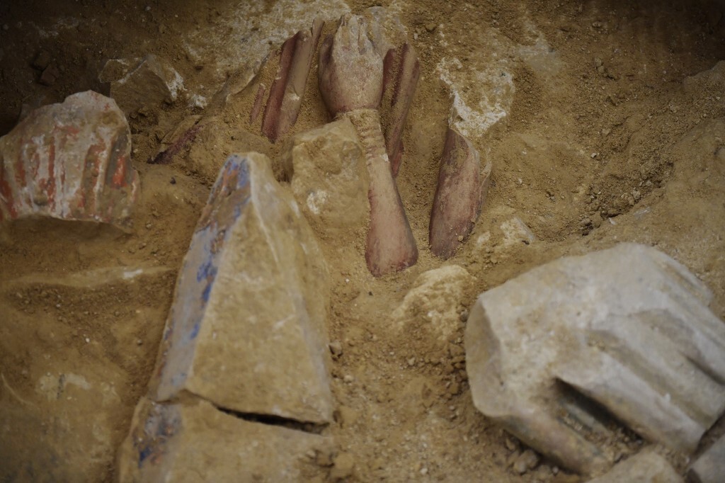 A pair of carved hands coming out of stone. 