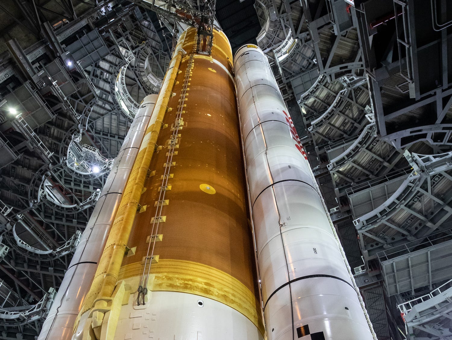 Looking up at towering work platforms surrounding central rocket.