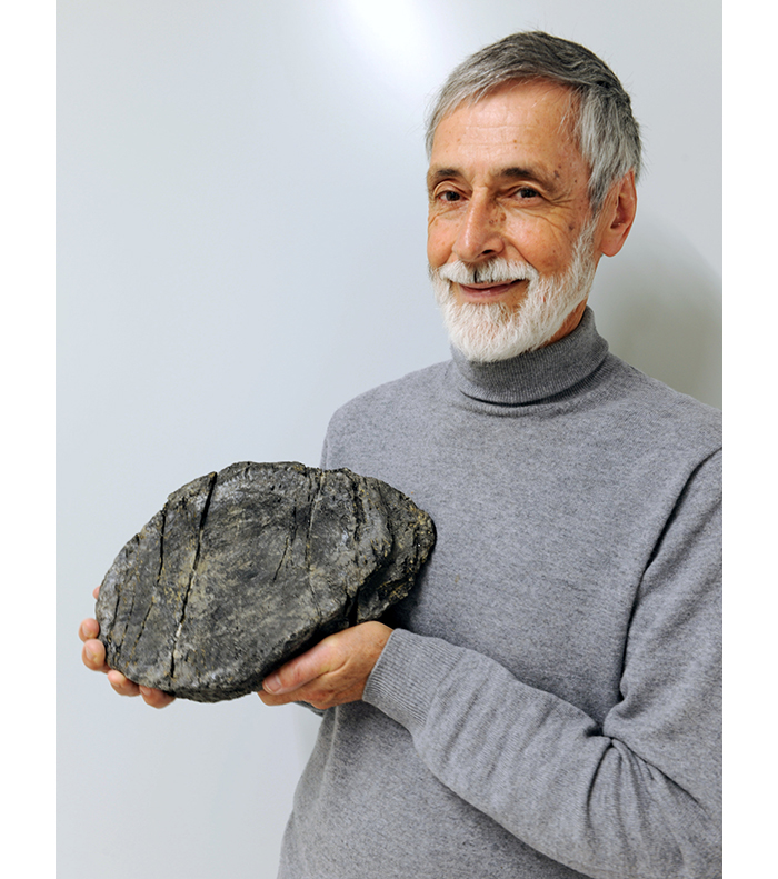 Heinz Furrer holding enormous vertebra