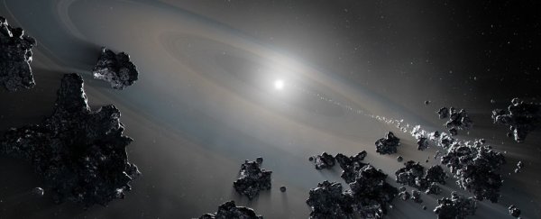 A dead star has been caught ripping apart its planetary system