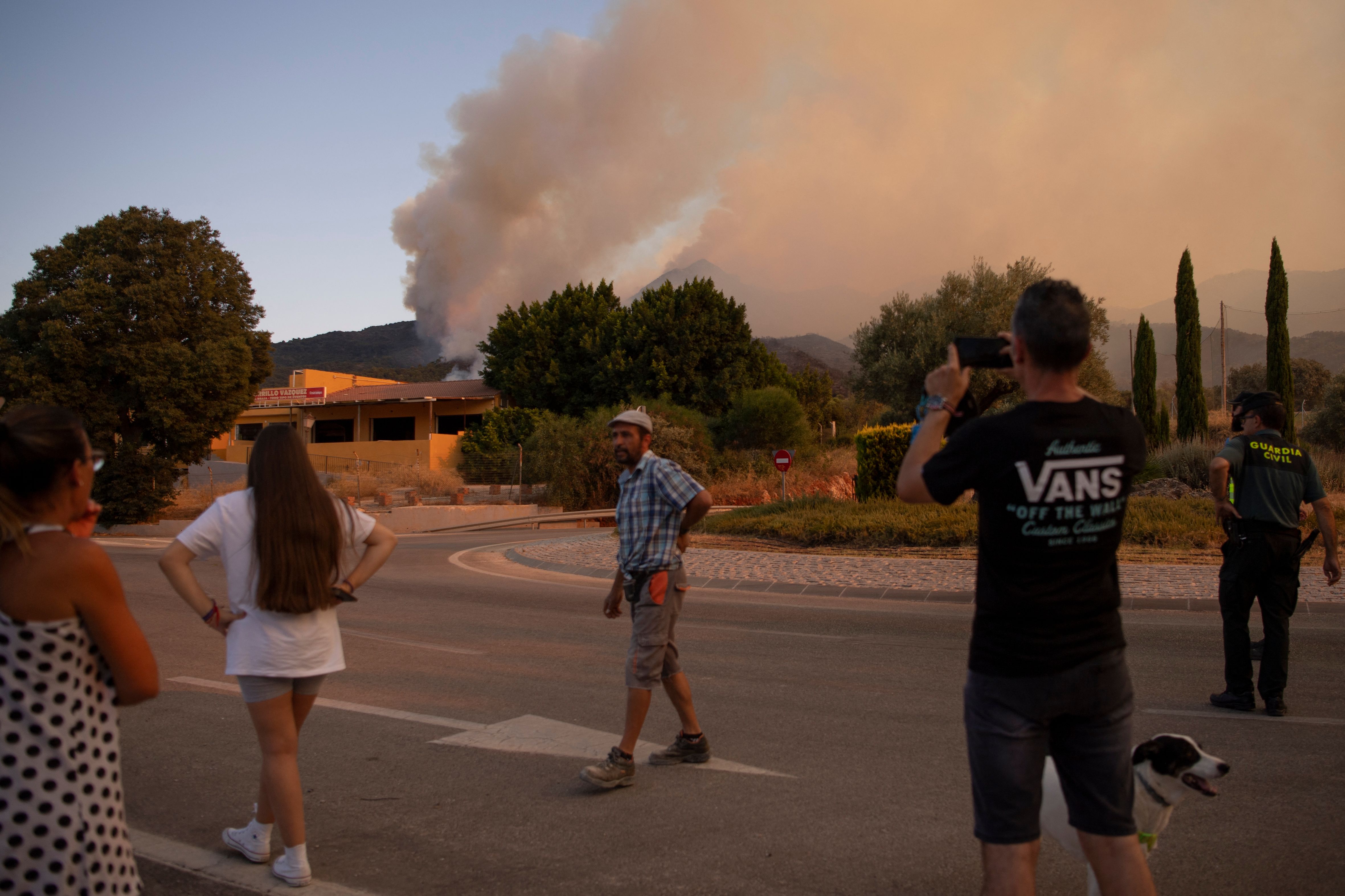 People watch wildfire smoke approach.