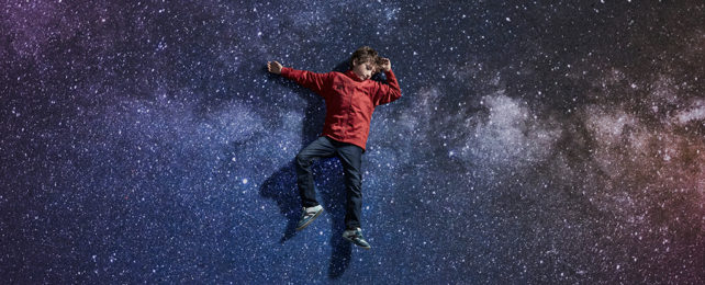 Boy laying on a background of stars