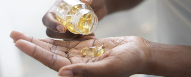 Capsules being put into a hand