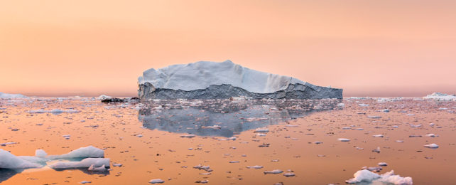 Iceberg against an orange sky