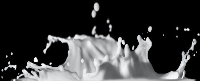 Milk splashing against black background