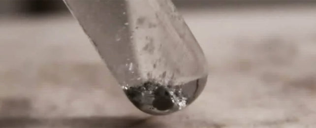 An aluminum-gallium alloy reacting with water in a test tube