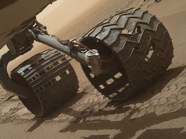 Close up of the damaged wheels of the Curiosity Mars rover.