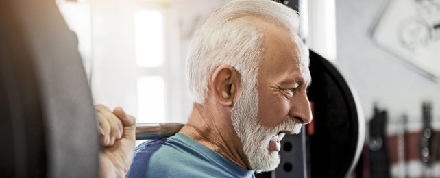 Elderly man lifting weights