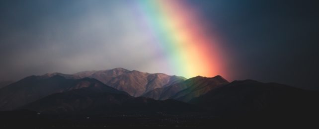 Rainbow Over Dark Mountains