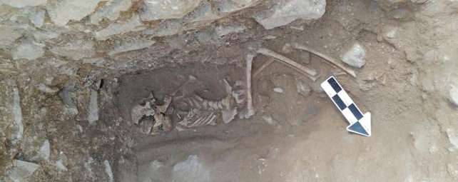A skeleton in a deep pit.