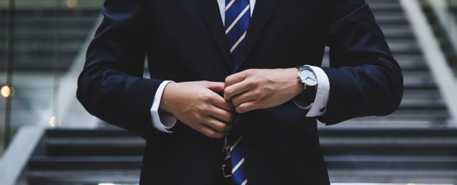 A male torso with a suit and tie