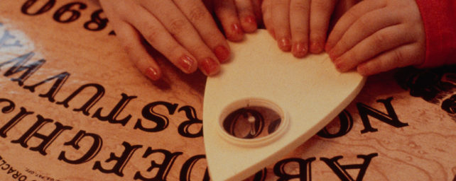Children using a Ouija board