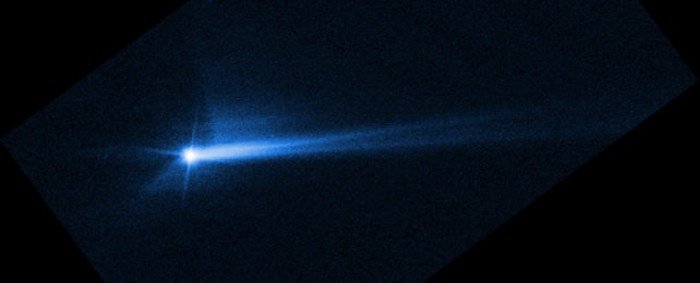 A streaking blue orb in space, the Dimorphos asteroid.