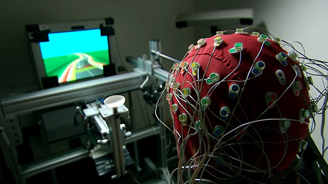 EEG cap on a person playing a video game