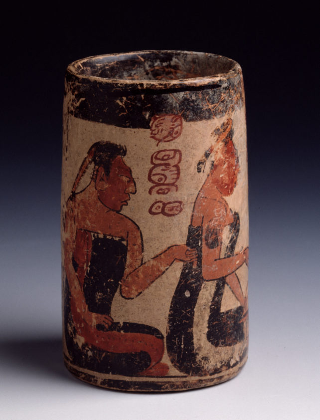 Un cuenco de 11,2 cm de alto con dos figuras mayas encima