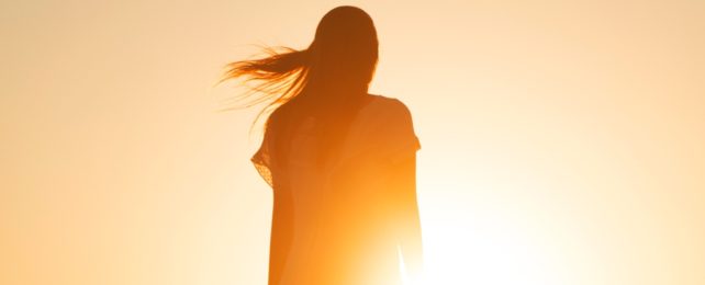 Woman Silhouetted By Sunlight